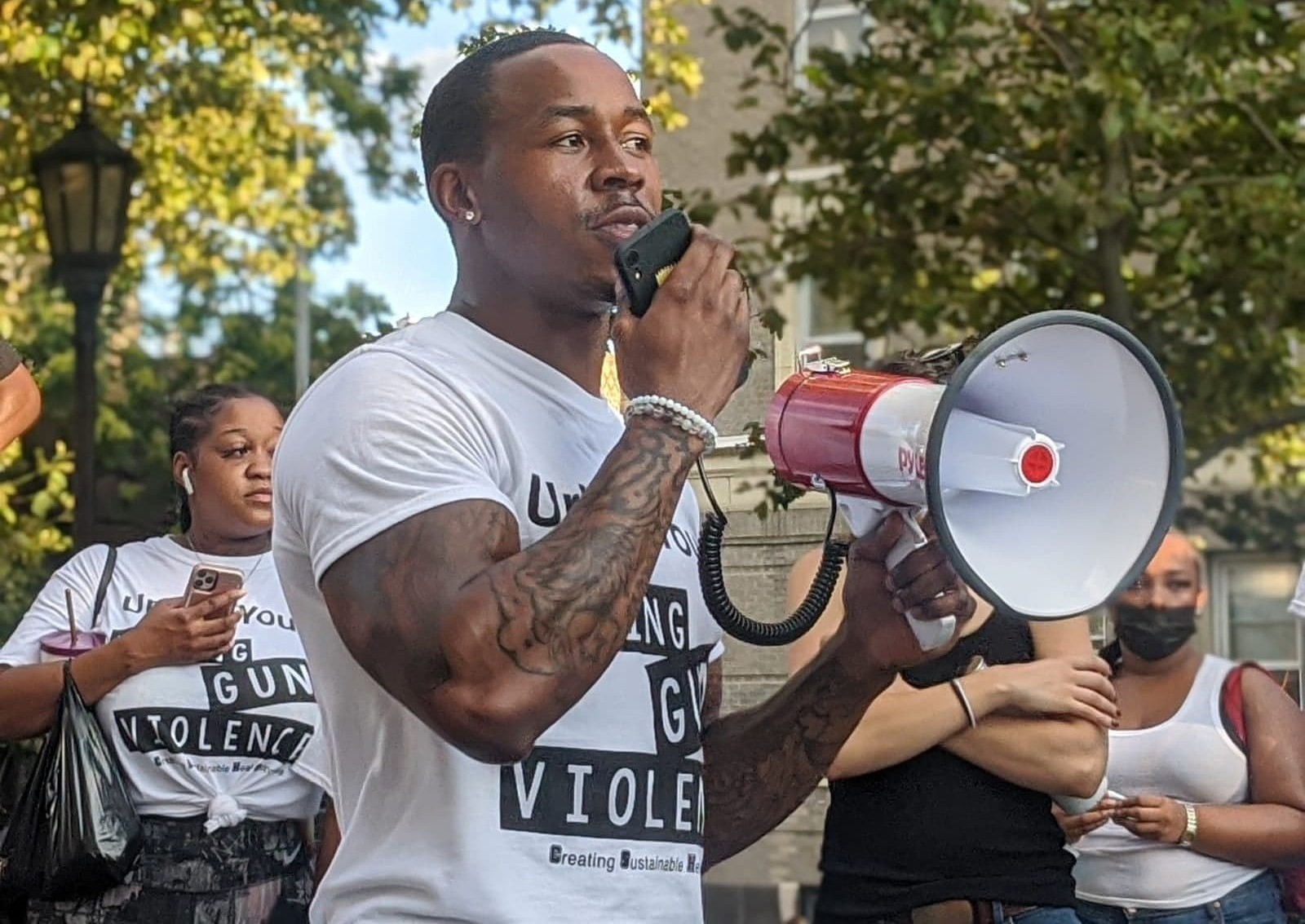Jarrell Daniels speaks into megaphone at rally