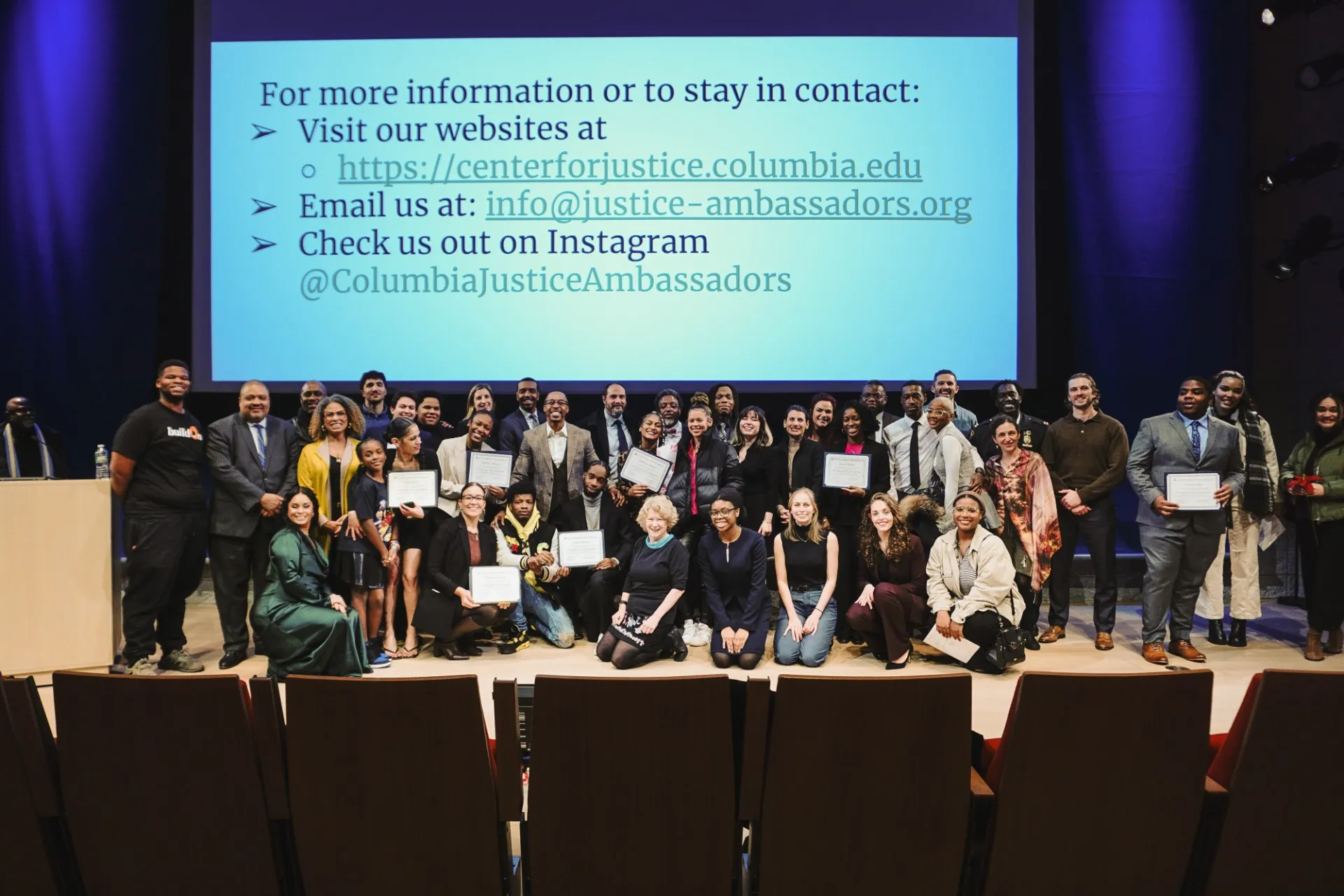 Group picture of JAYC graduates holding their certificates and Center for Justice staff at the Forum