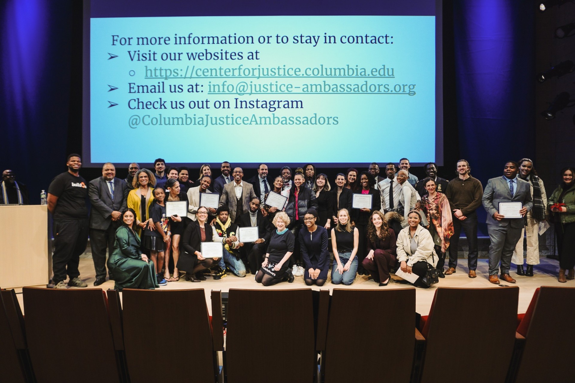 Group picture of JAYC graduates holding their certificates and Center for Justice staff at the Forum