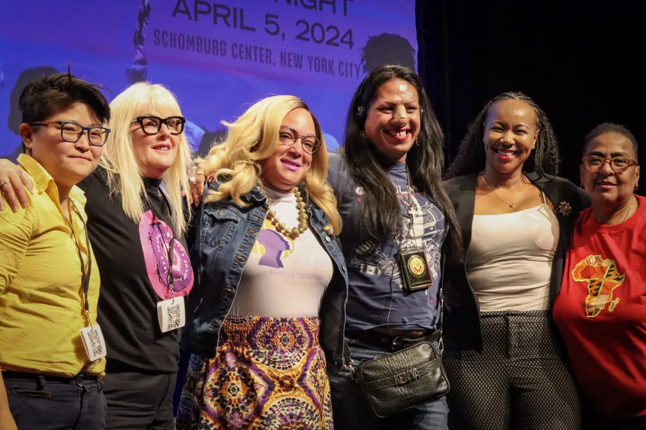 Group photo of all of the panelists on stage 