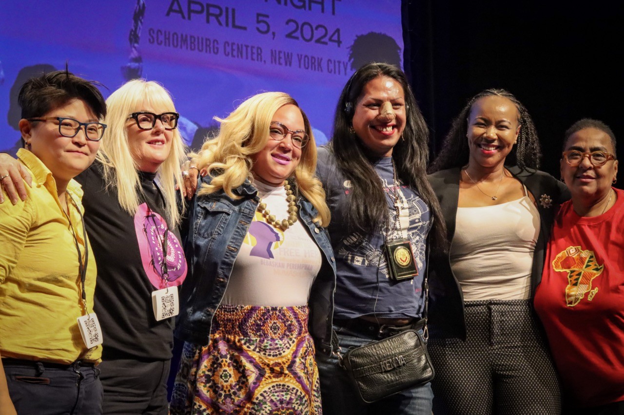 Group photo of all of the panelists on stage