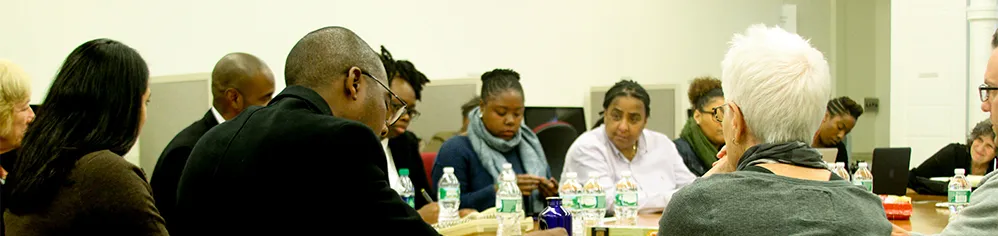 Center for Justice conference attendees discuss issues around a round table.