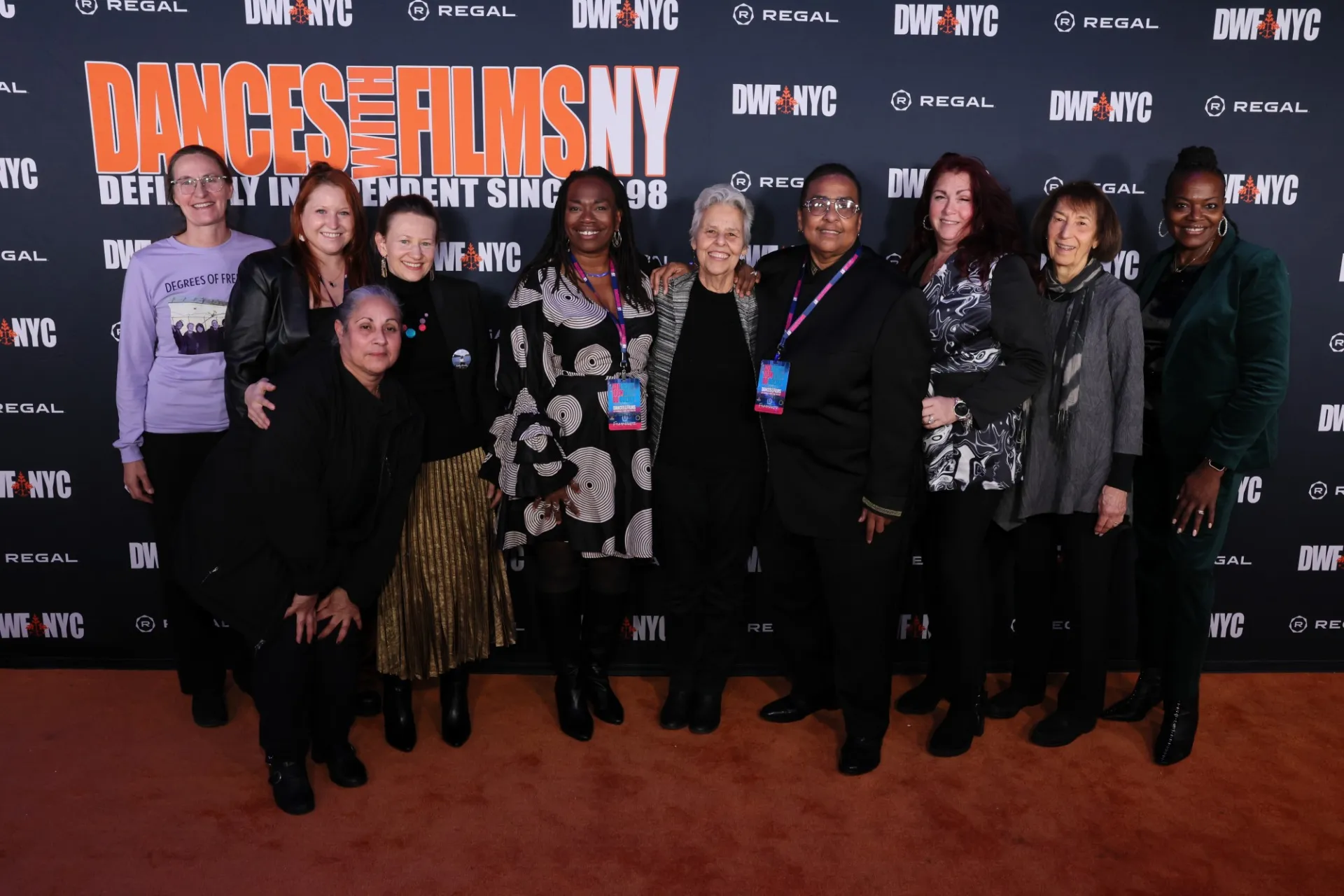 A group of women standing in front of a step and repeat that says "Dances With Films Festival NY"