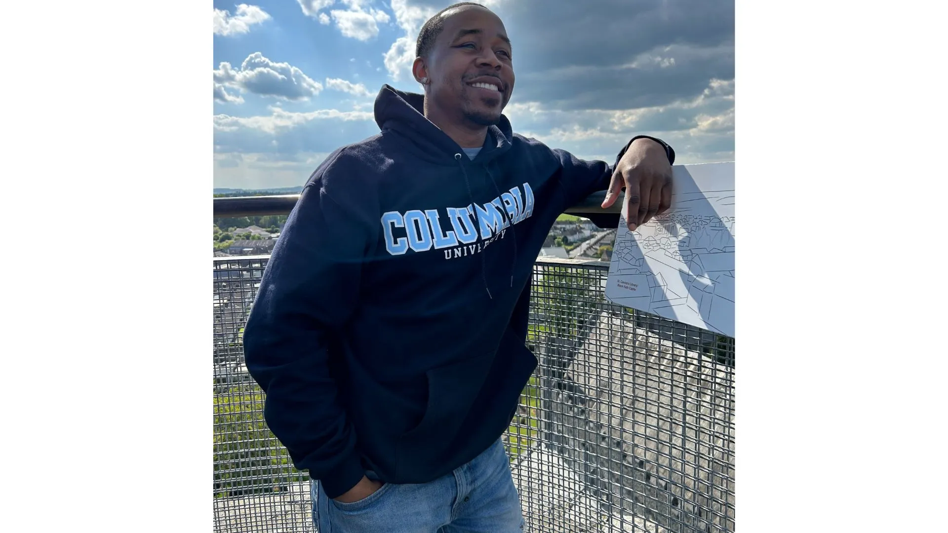 Photo of a man smiling with a Columbia hoodie on