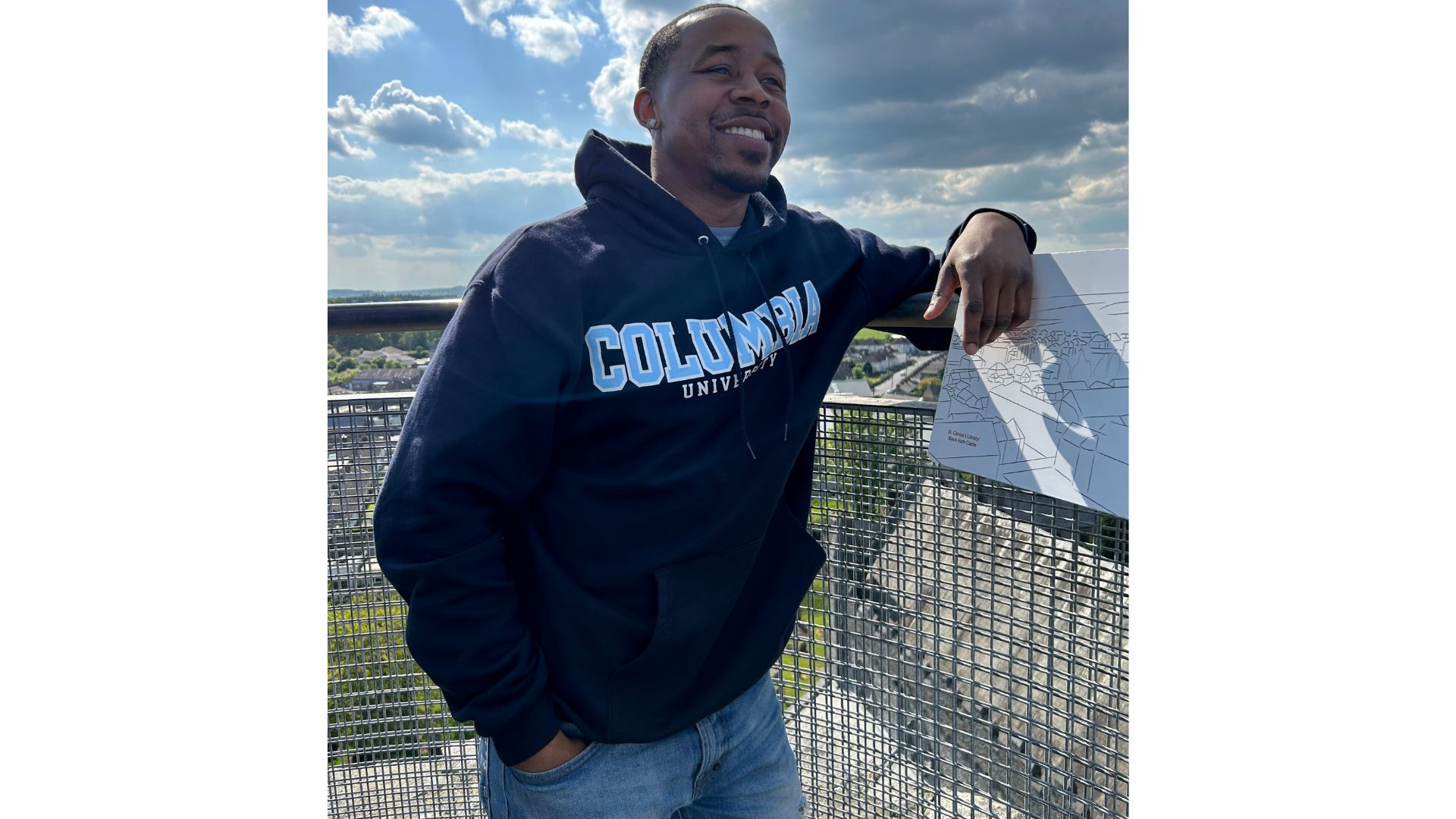 Photo of a man smiling with a Columbia hoodie on