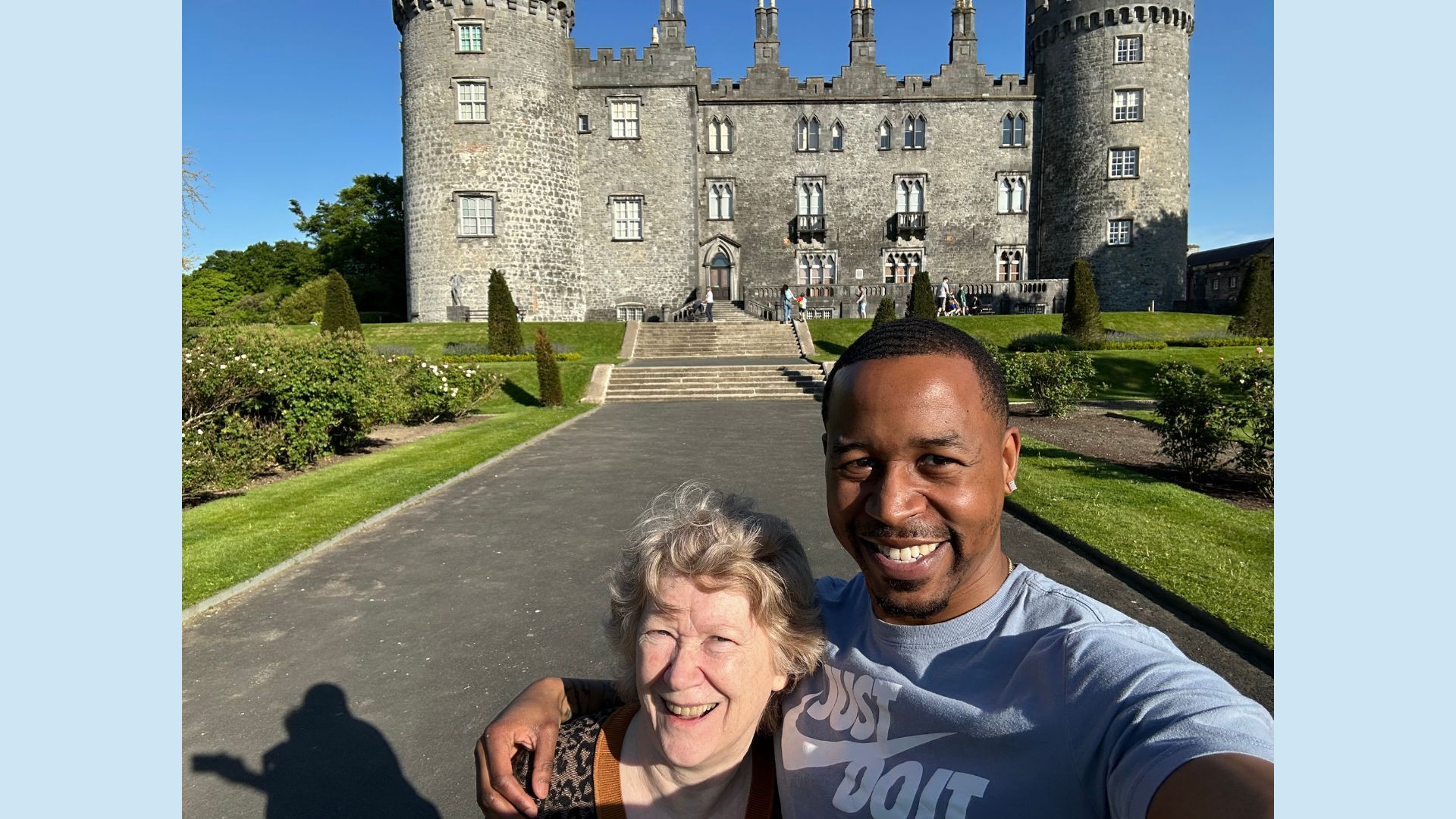Man and woman smiling in front of a castle in Ireland
