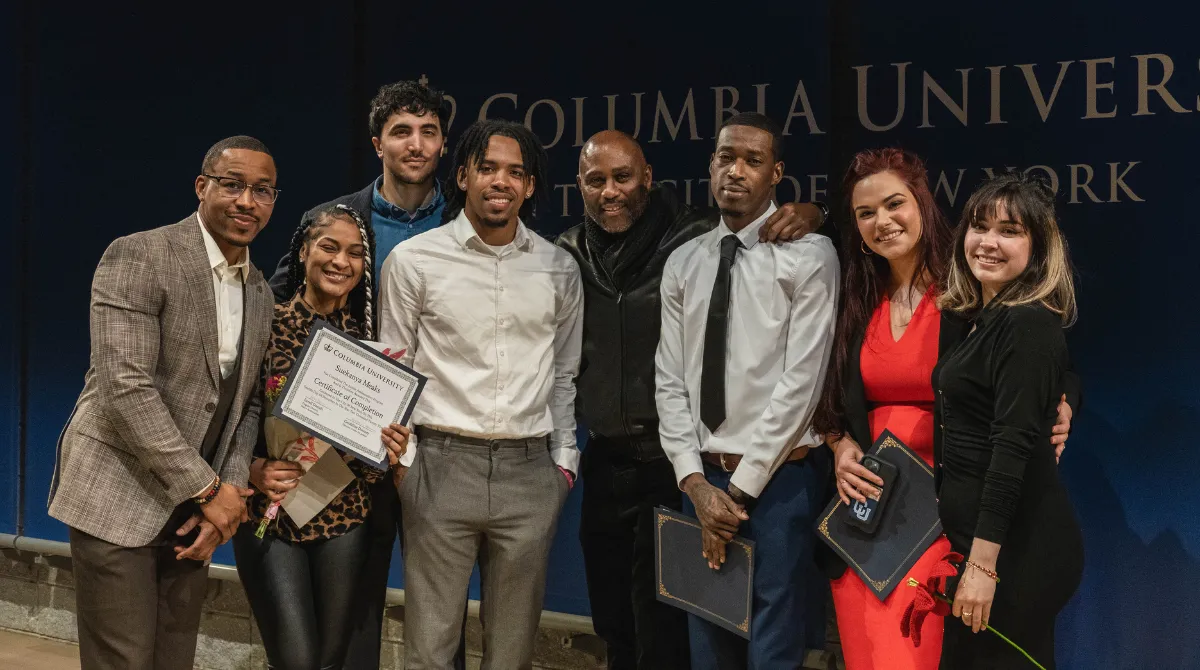 Group picture of program graduates with their certificates