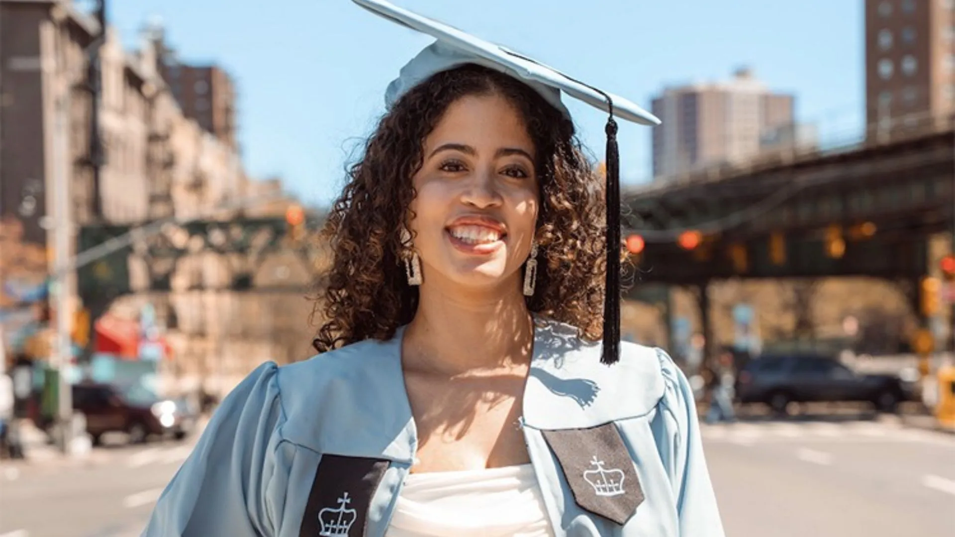 Photo of a woman in a Columbia graduation cap and gown