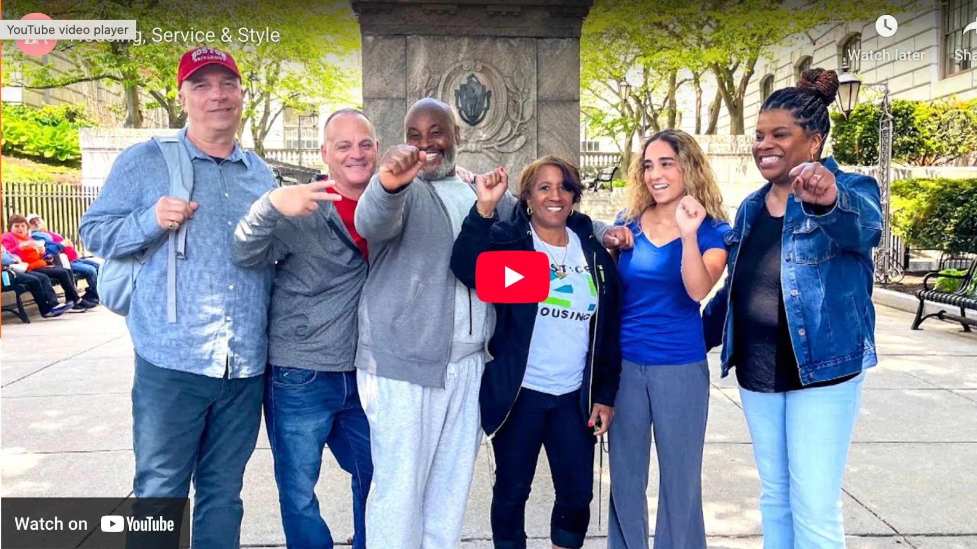 Screenshot of a youtube thumbnail of a group of people with fists in the air
