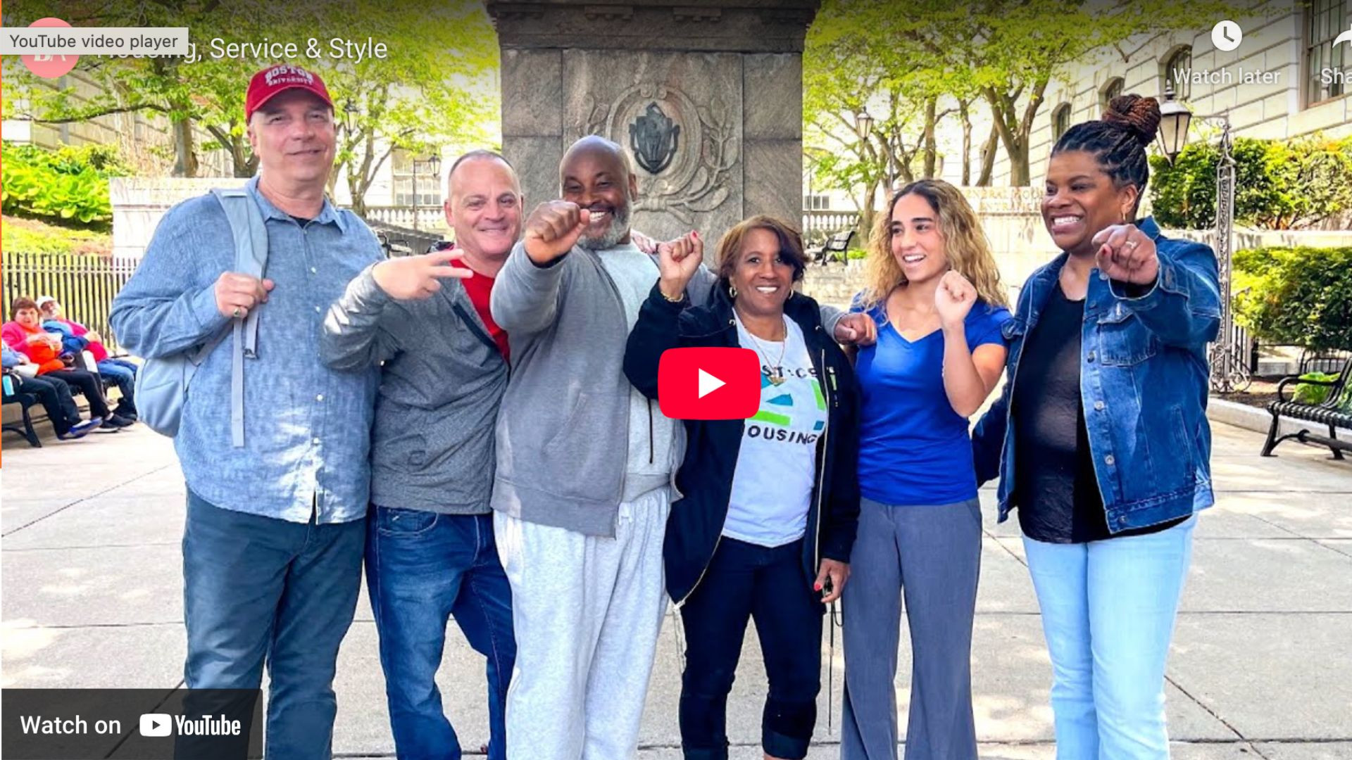 Screenshot of a youtube thumbnail of a group of people with fists in the air