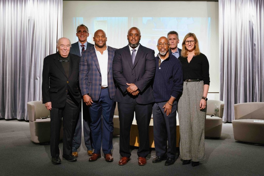 A group of panelists standing together for a picture
