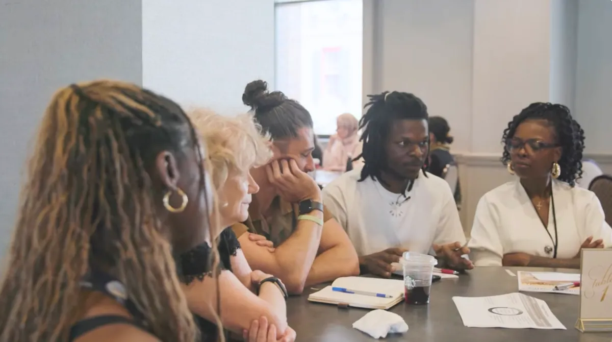 Group of people sitting at a table talking