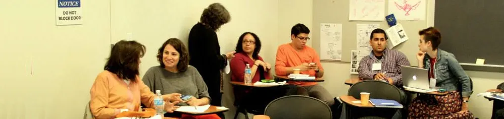 Center for Justice event attendees are seated in pairs discussing issues in the corner of a classroom