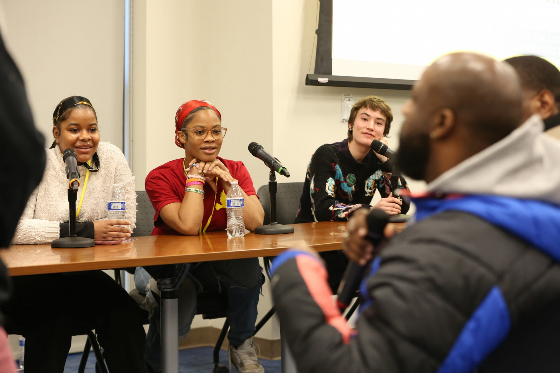 Photo from of a panel of speakers that includes the crowd