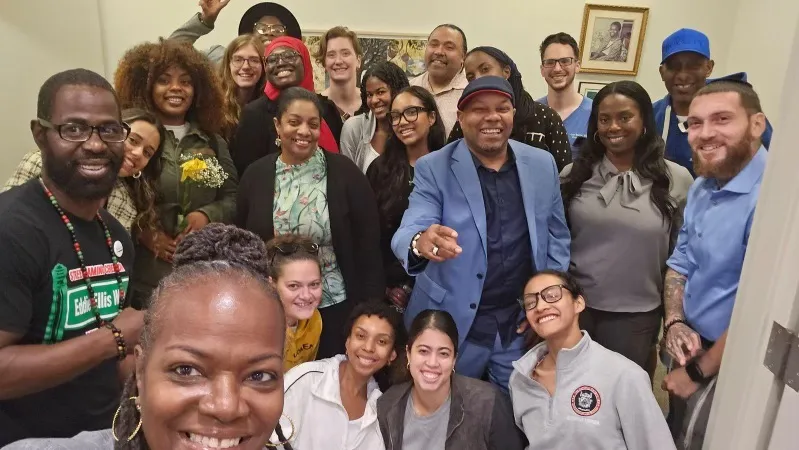 Selfie of a large group of people smiling