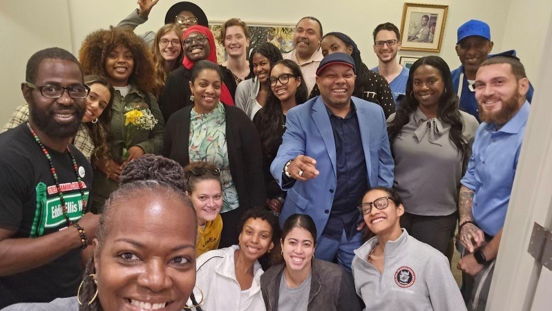Selfie of a large group of people smiling