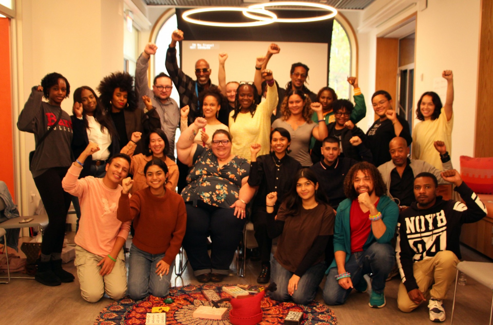 Group photo of people with fists in the air