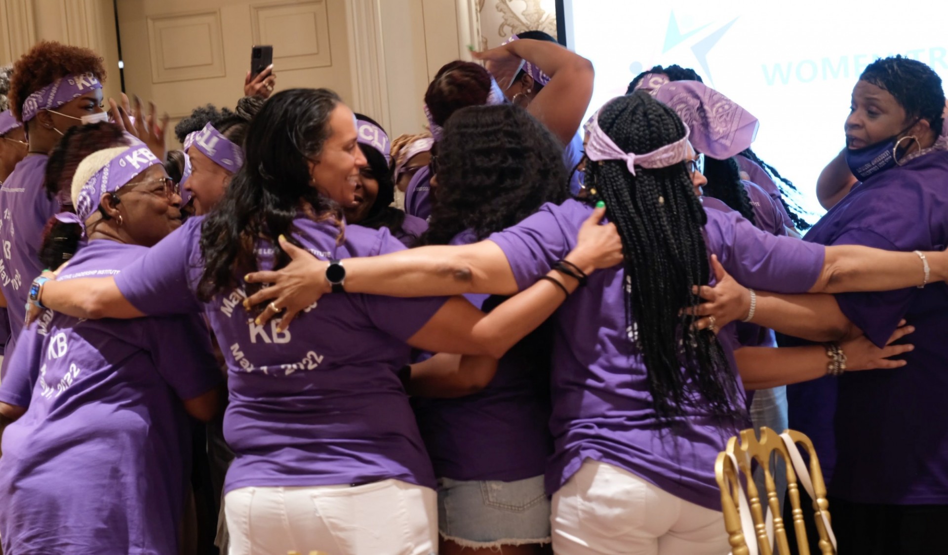Women Transcending participants hugging in a group