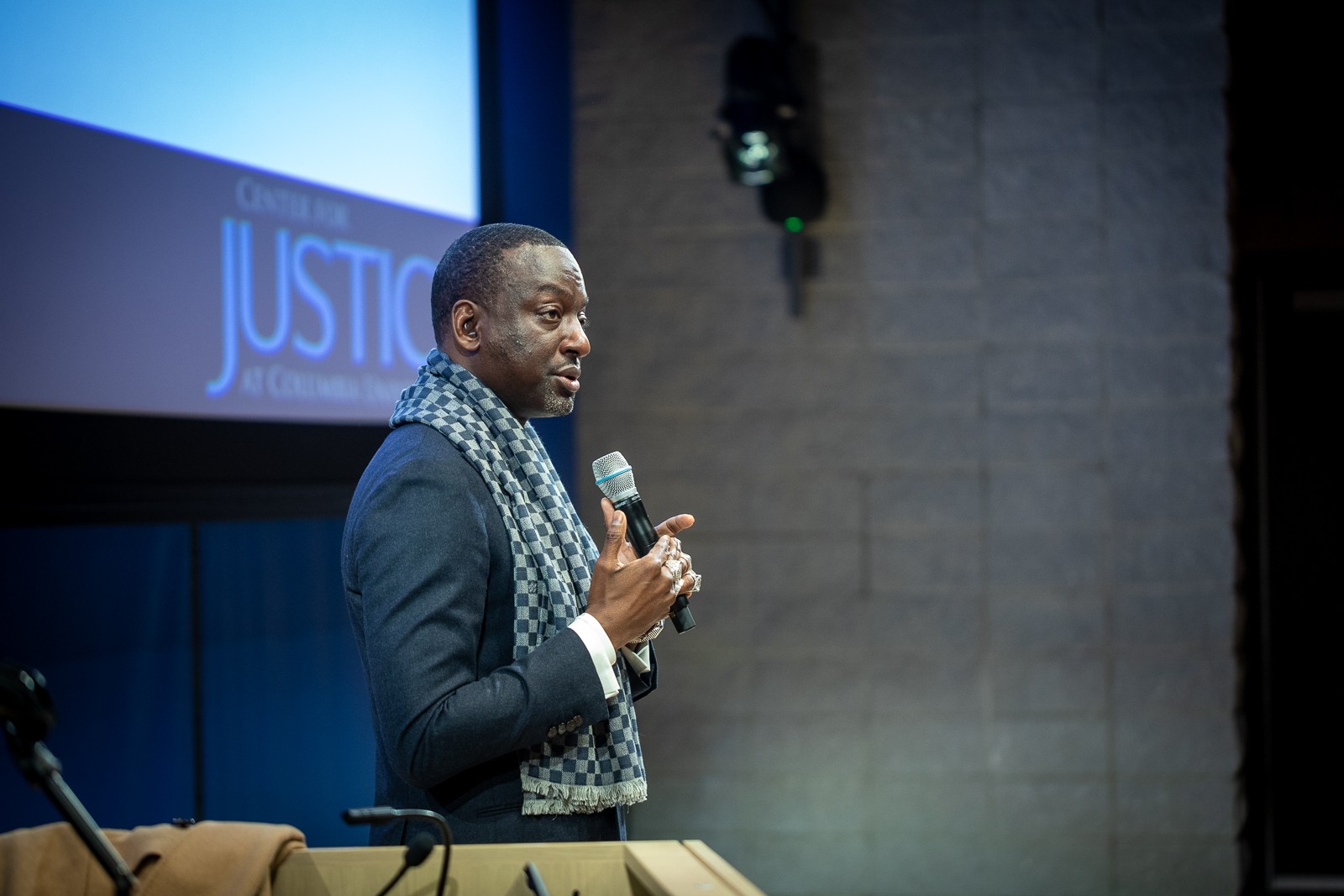 Picture of Yuseef Salaam speaking at the JAYC graduation