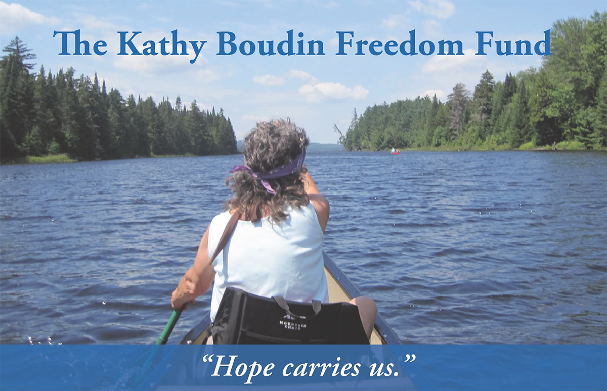 The Kathy Boudin Freedom Fund. Photo of an older woman with grey hair and a bandana on in a kayak. Words at the bottom: "Hope carries us."